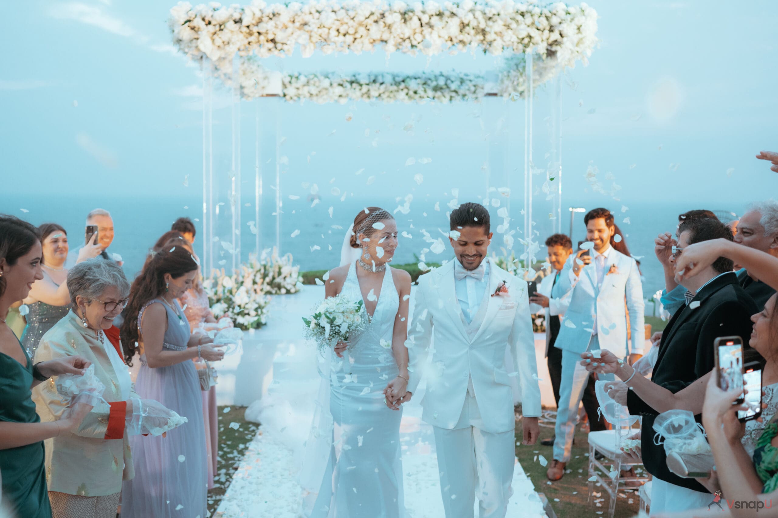 Bride and groom walk back to their wedding venue under the moonlit sky at their destination wedding.